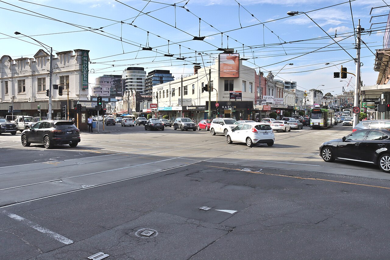 Camberwell Junction, Melbourne, with shops, cars and tram wires along Burke Road