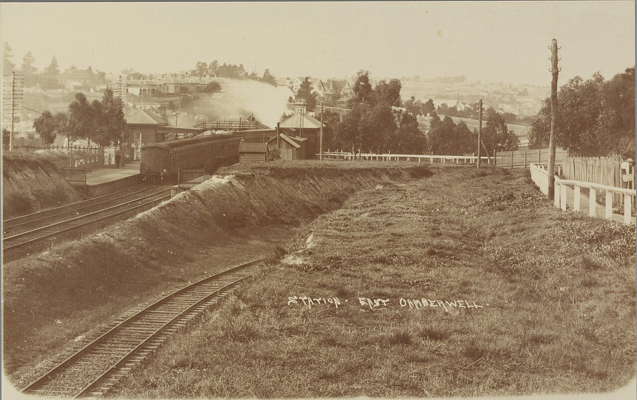 Sepia postcard of East Camberwell railway station, Melbourne, with a steam train at the platform, circa 1907