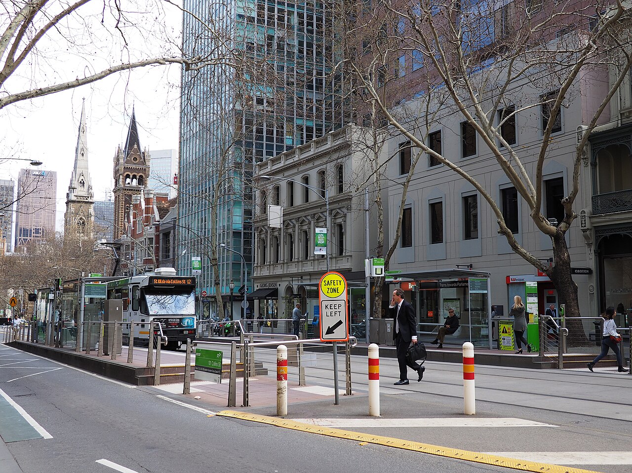 101 Collins Street tram stop with a church spire behind