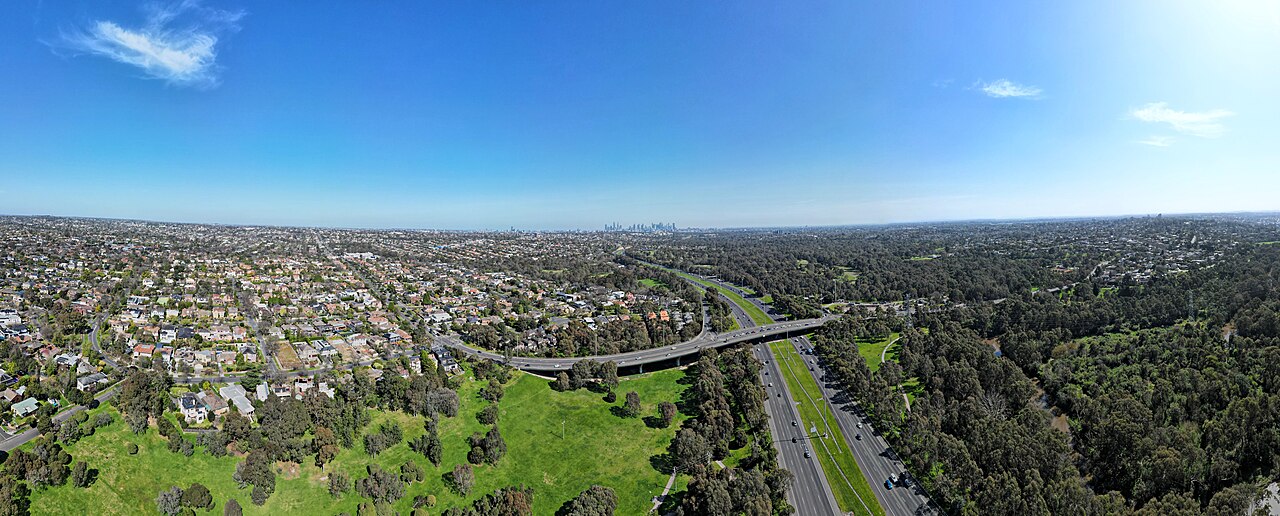 Aerial panorama of the Eastern Freeway through green parkland