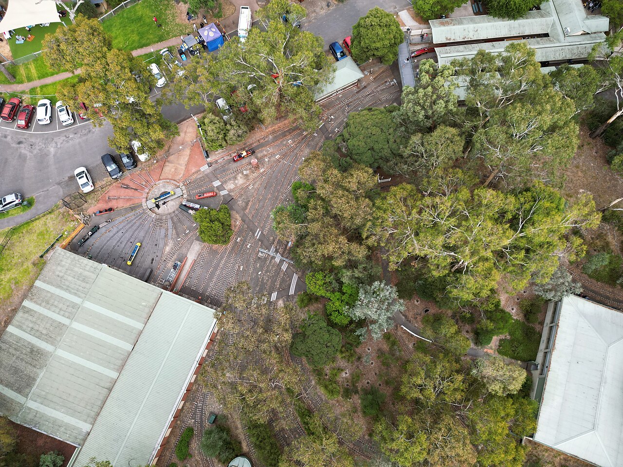 Aerial view of buildings and car parks among trees