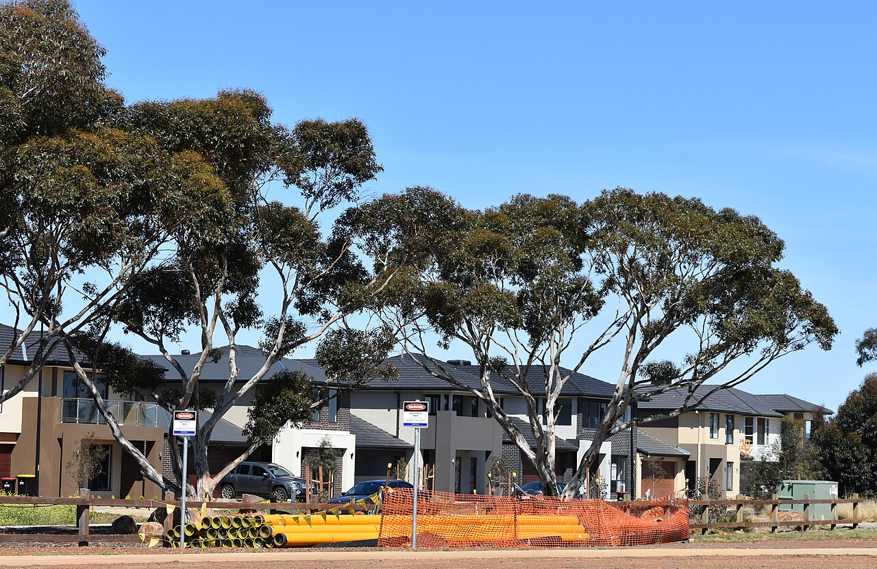 New houses behind gum trees in Woodlea, Aintree