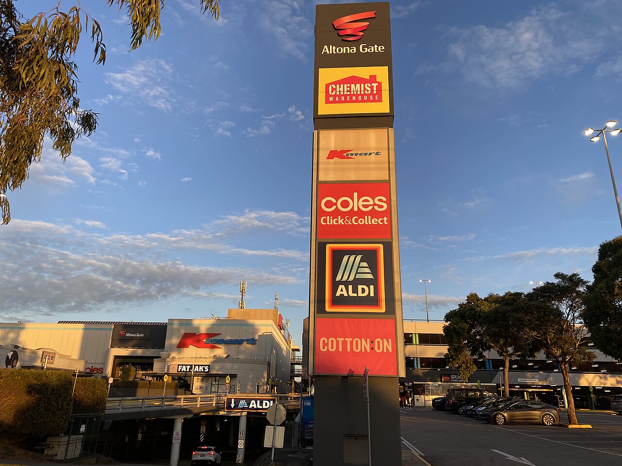 Altona Gate Shopping Centre exterior and store signs at dusk