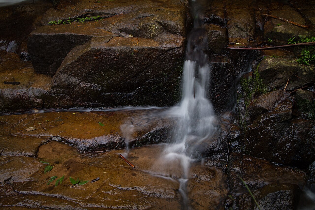 Small waterfall over dark rock
