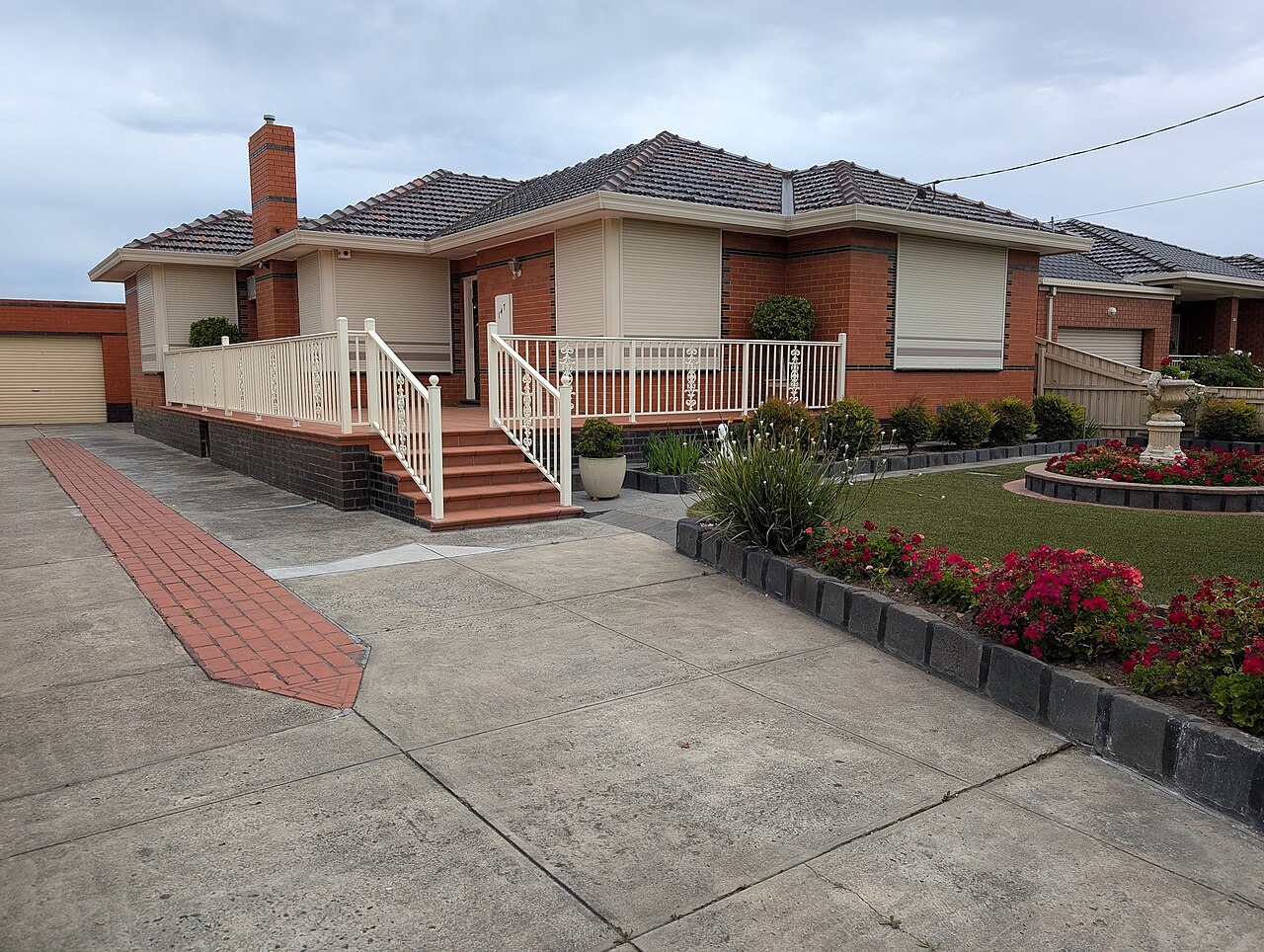 Brick house with rose garden on Massey Avenue, Reservoir