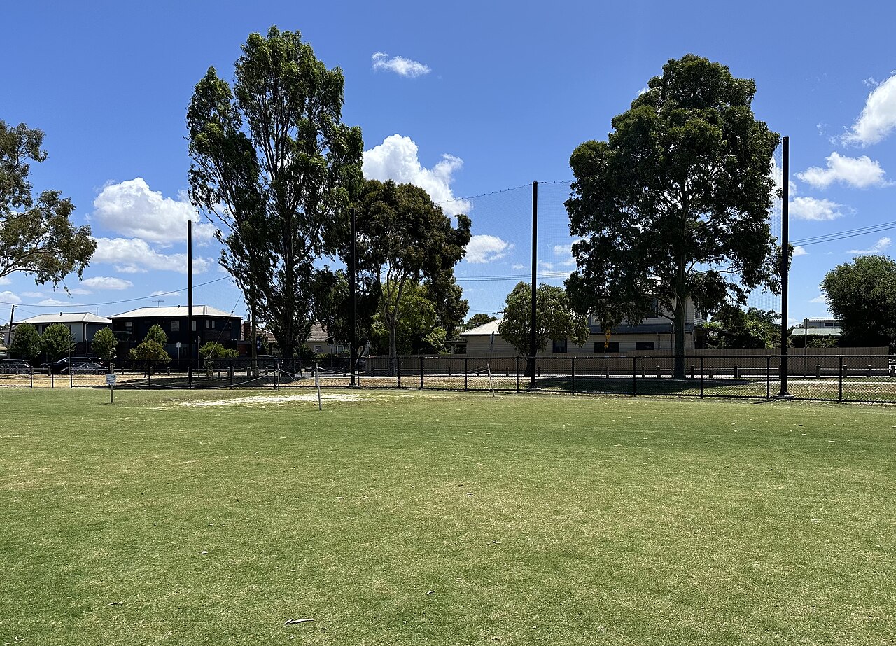 Grassy oval ringed by trees at Bryan Martyn Oval