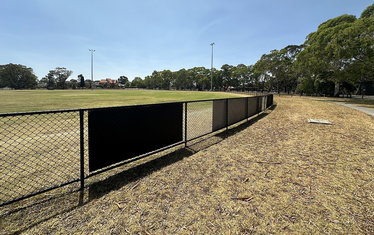 Bundoora Park Oval behind a fence