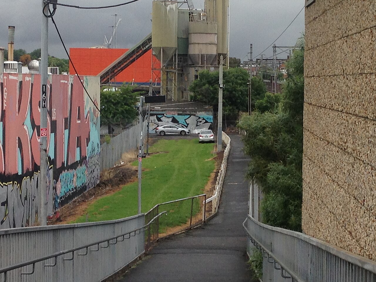 Graffitied laneway path beside the rail line near Victoria Park station