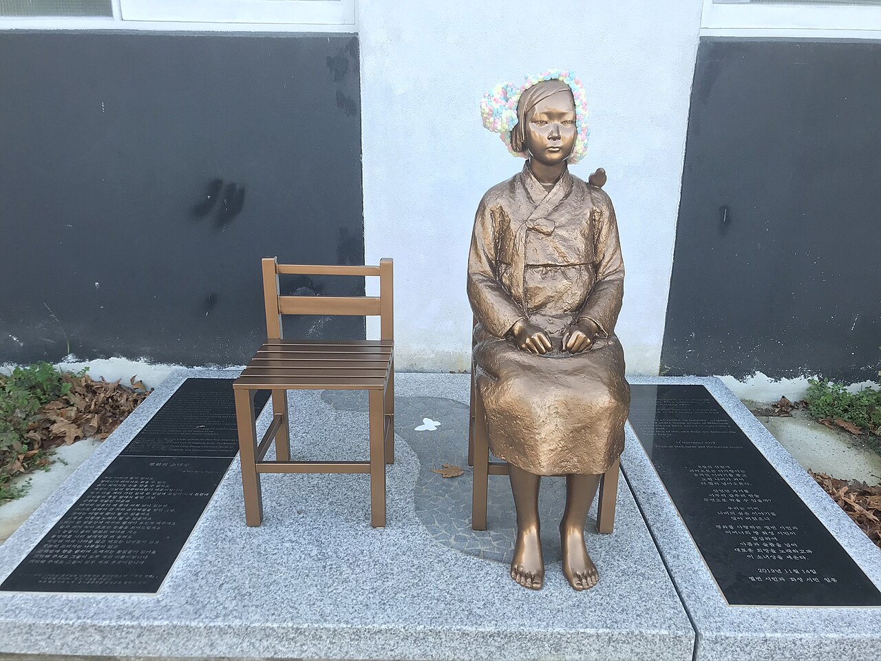 Bronze comfort woman statue on a public plaza