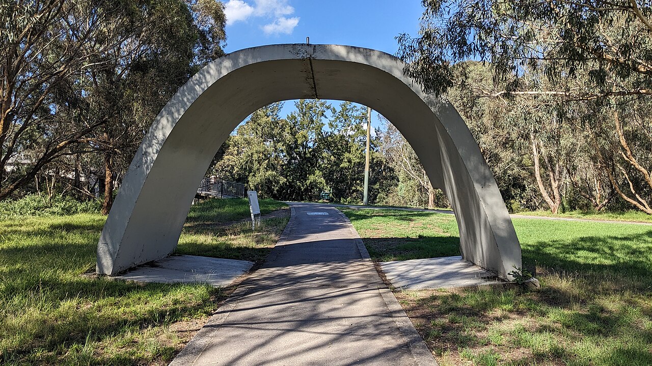 Concrete arch from original construction beside a shared path