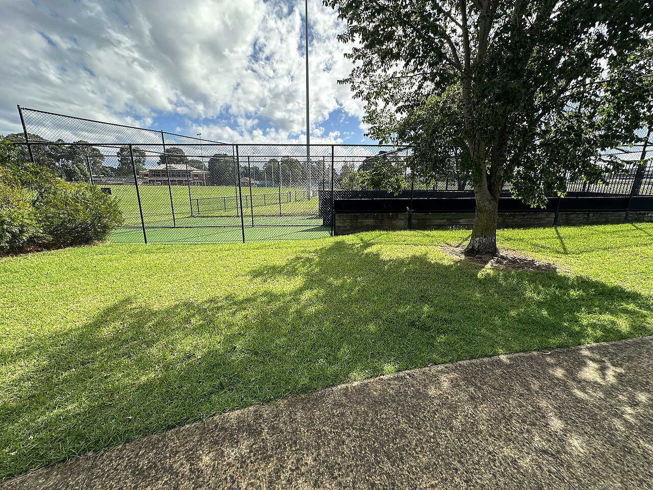 Grassy slope and tennis courts at Glen Huntly Park