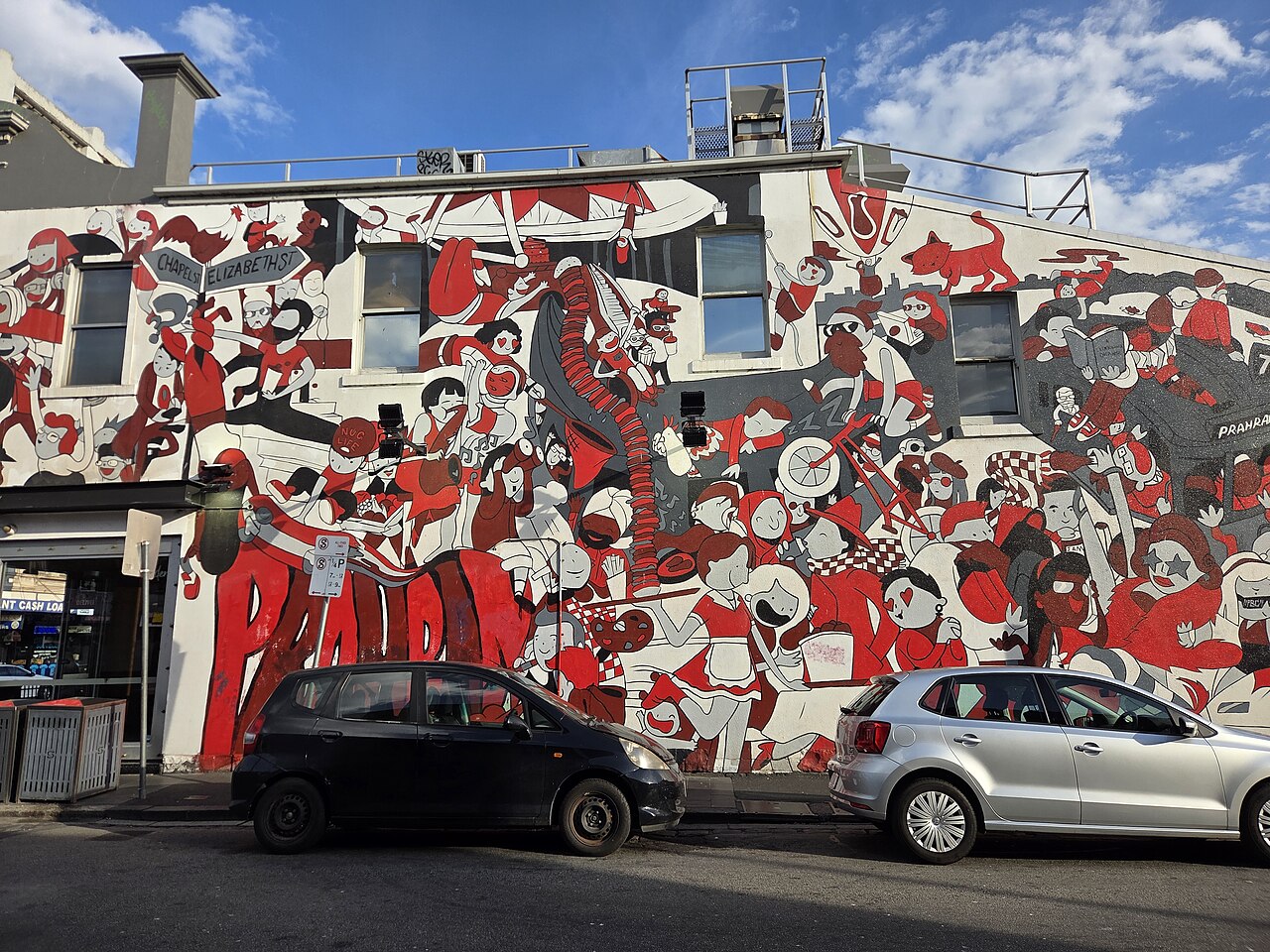 Large red, white and black graffiti mural on a wall in Prahran