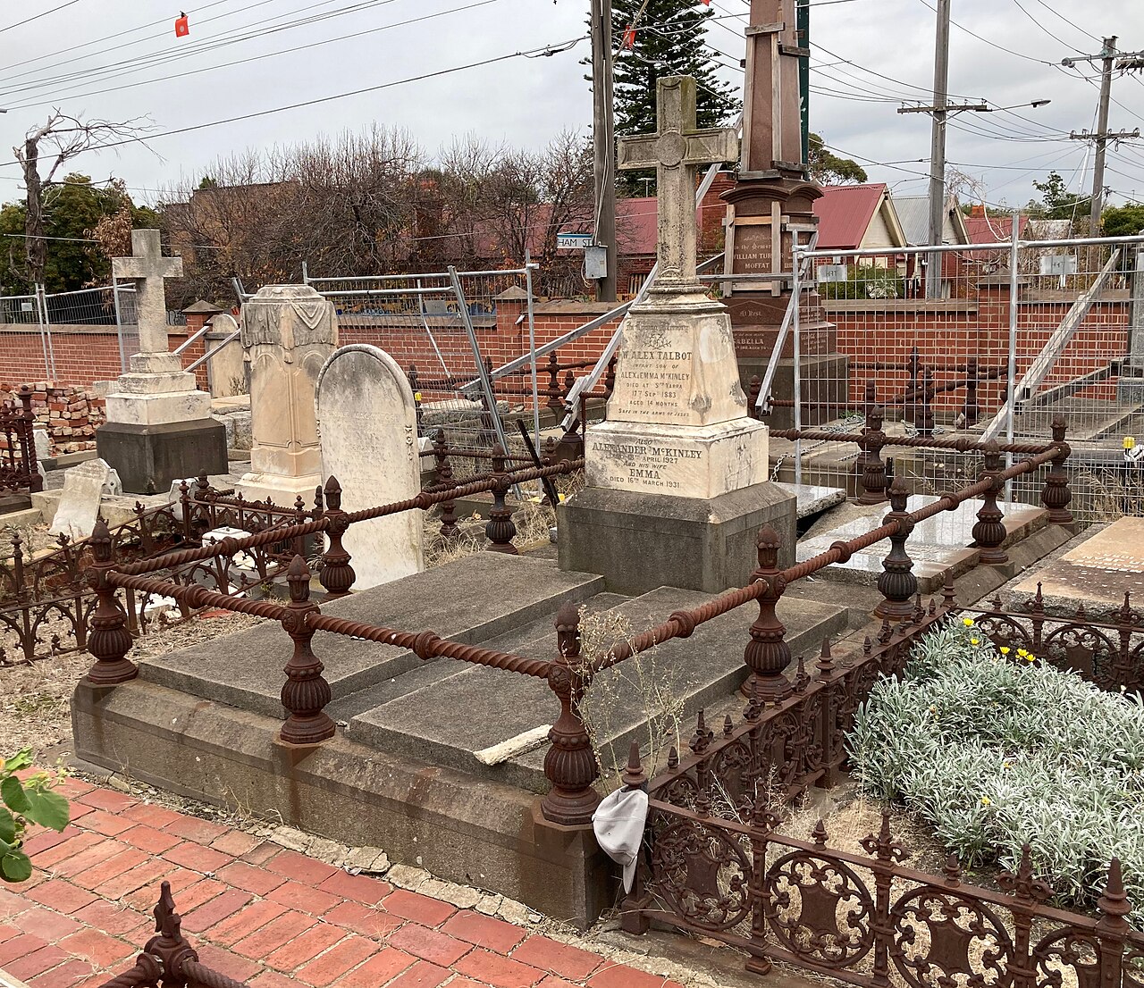 Ornate Victorian-era graves with iron railings in a cemetery