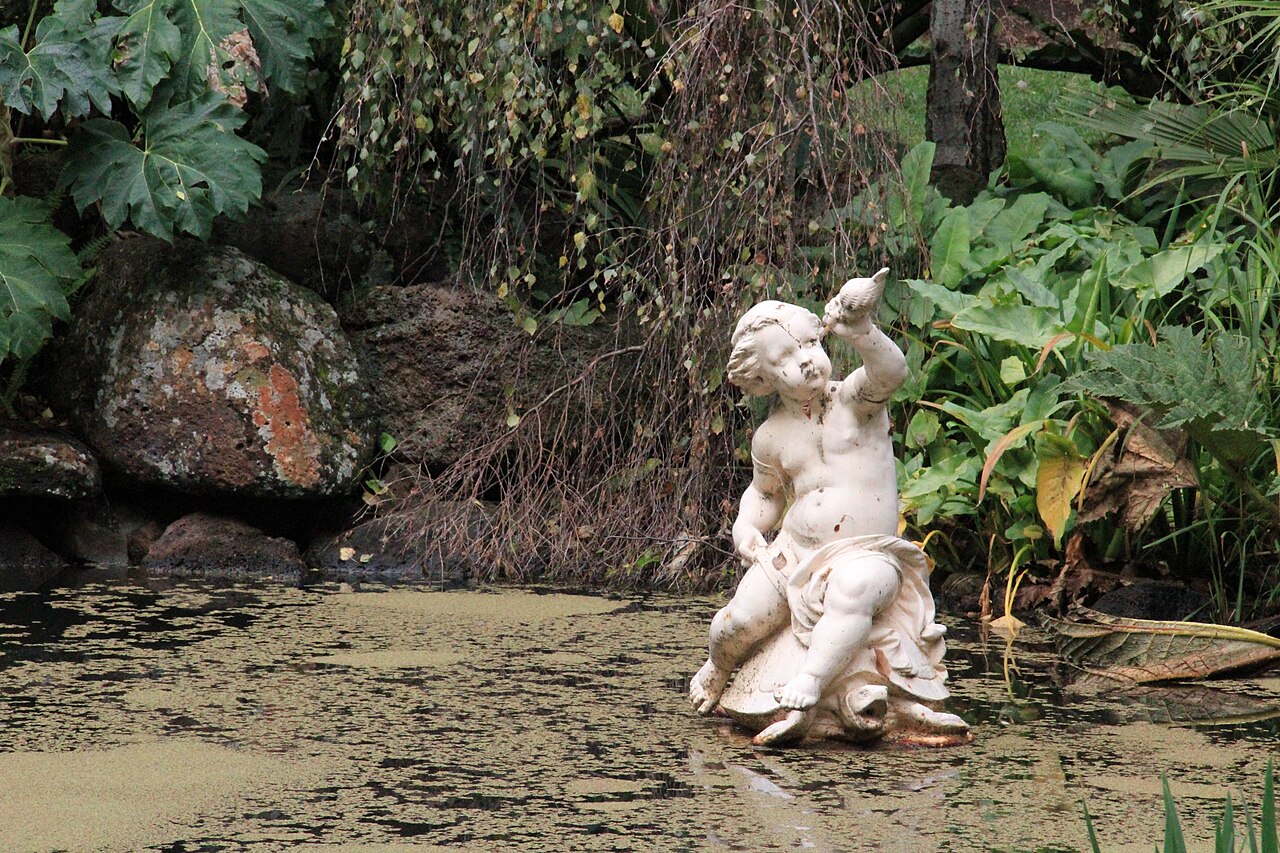 Statue by a pond in Fitzroy Gardens