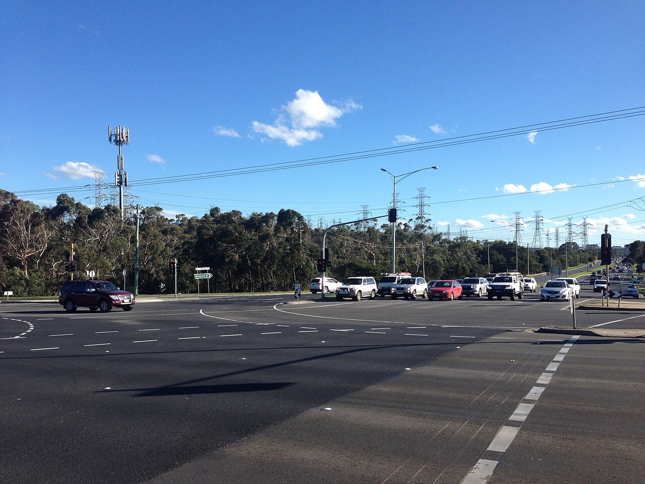 Intersection of Stud Road and Wellington Road under a blue sky