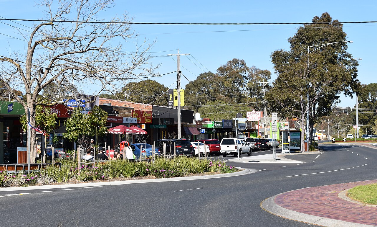 Keilor shopping strip with shops and parked cars