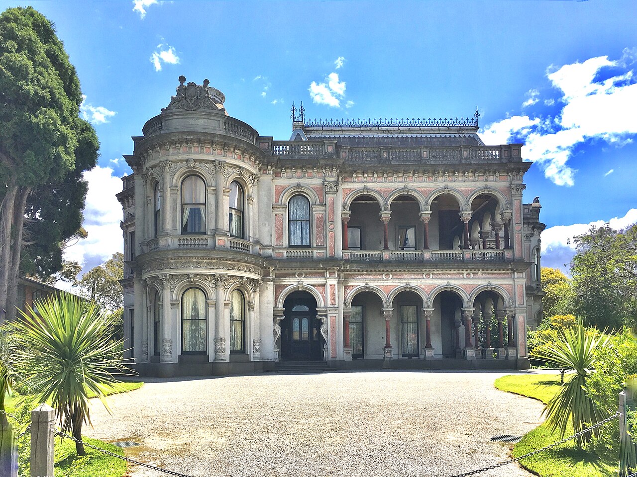 Front entrance of the Labassa mansion under a blue sky
