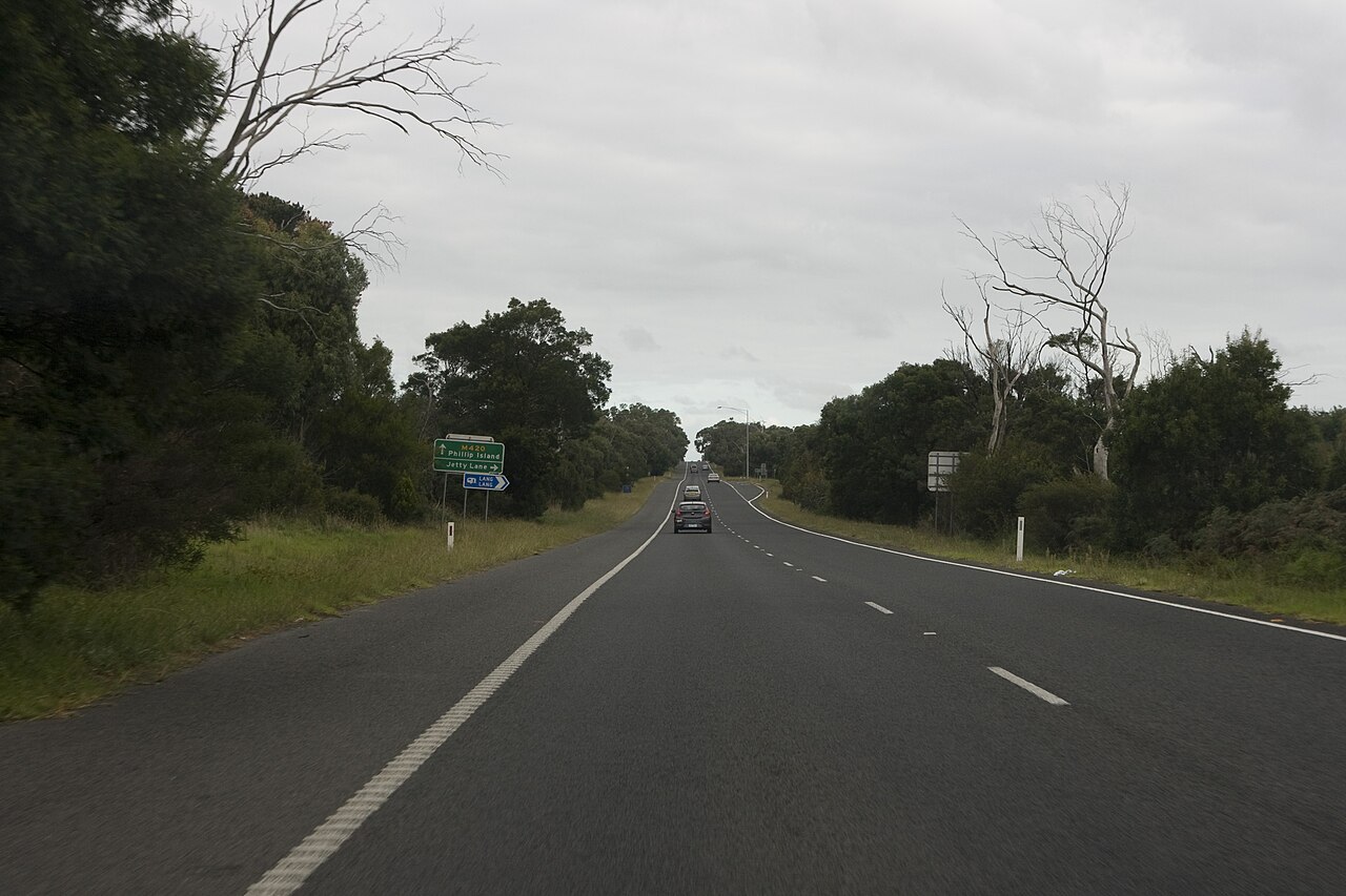 Rural highway through Lang Lang lined with trees