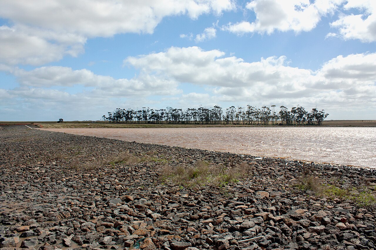A full lake at Manor Lakes under a cloudy sky