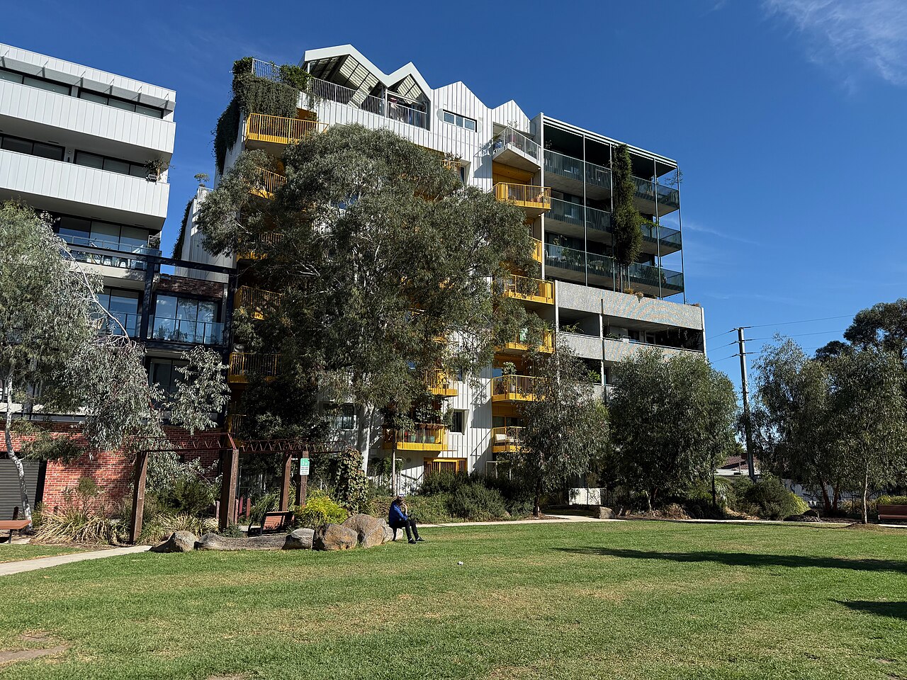 Apartment buildings at Nightingale Village behind a lawn