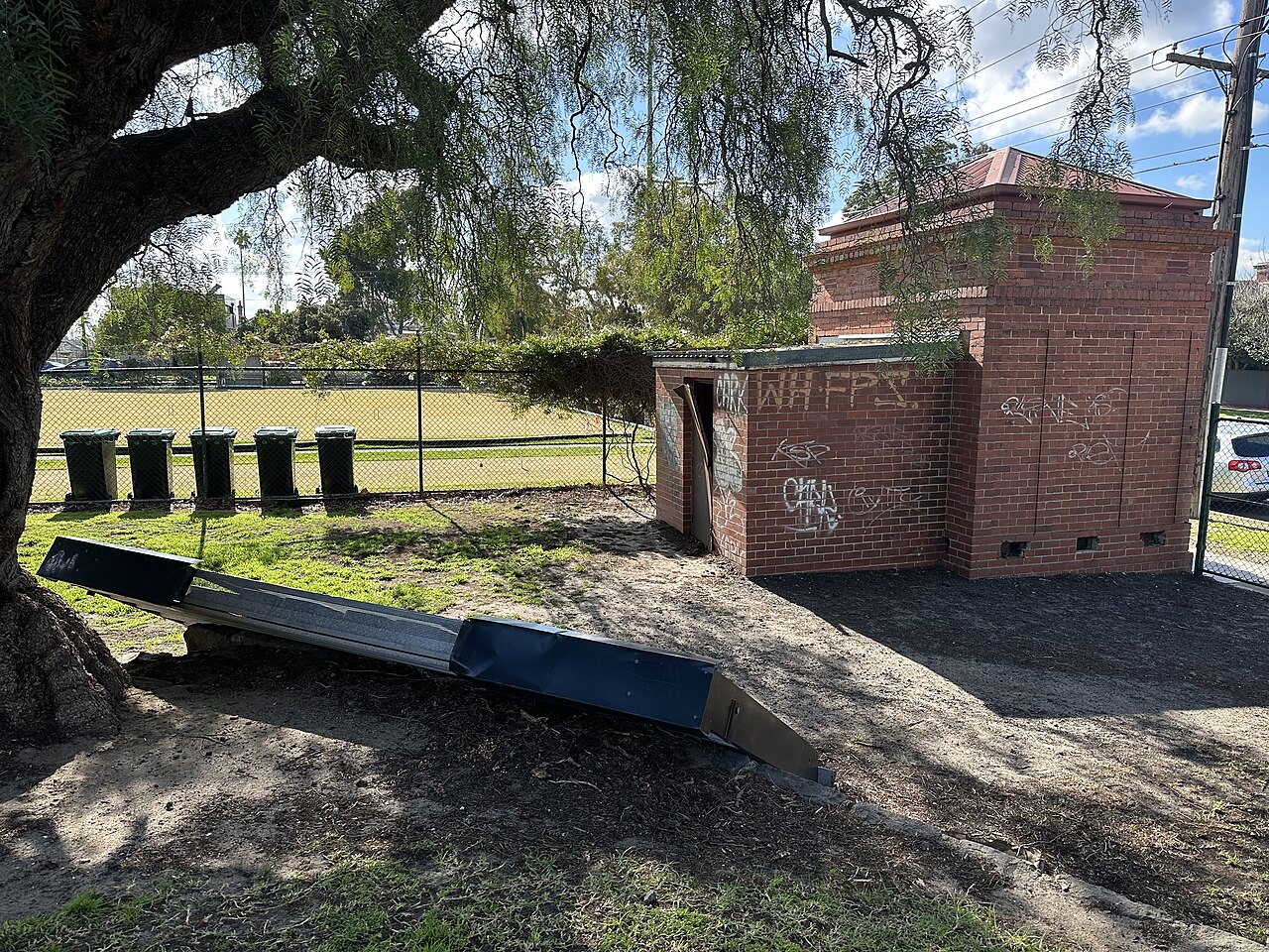 Old brick scoreboard building beside the oval at Windy Hill