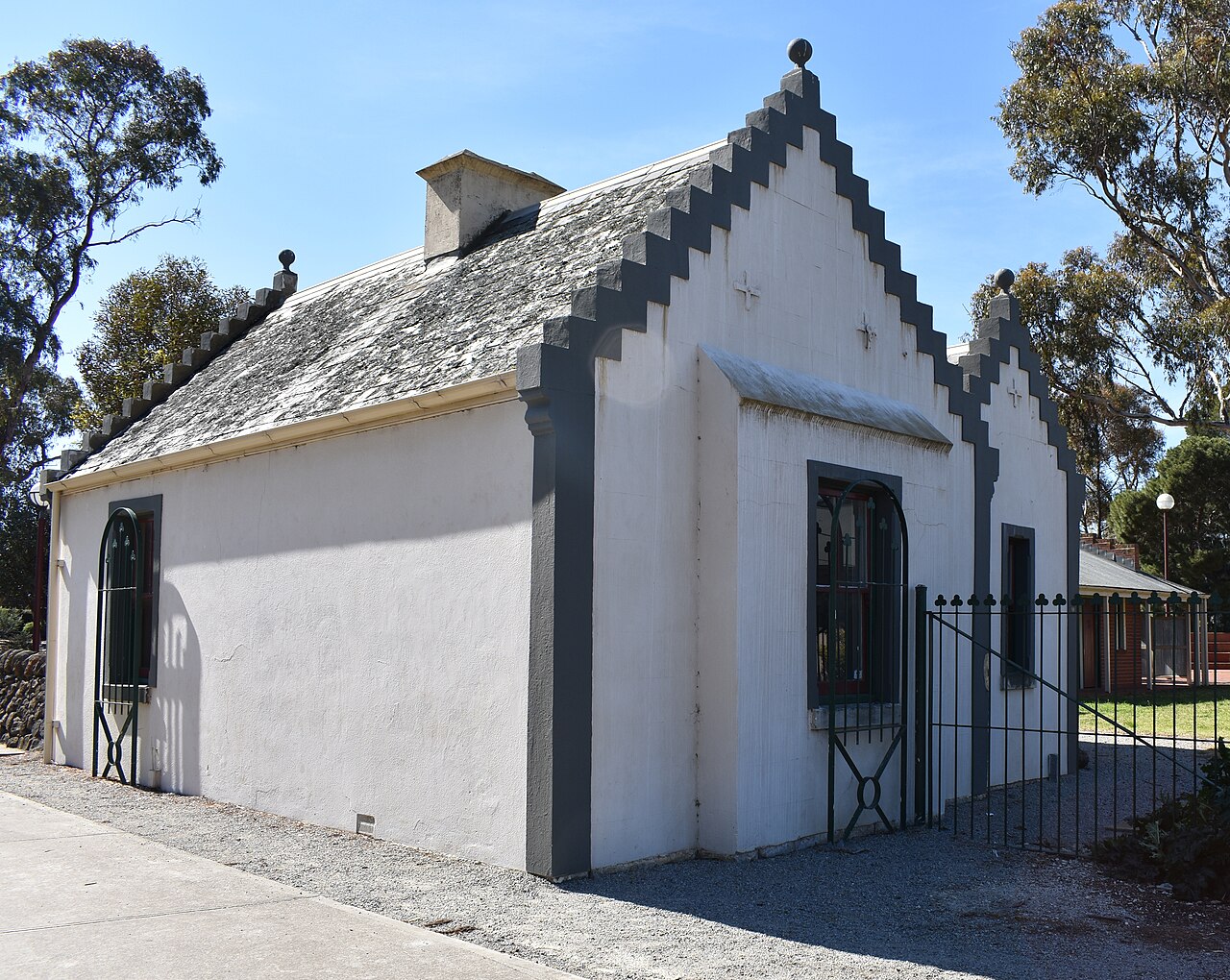 Whitewashed Overnewton Gatehouse with a stepped gable