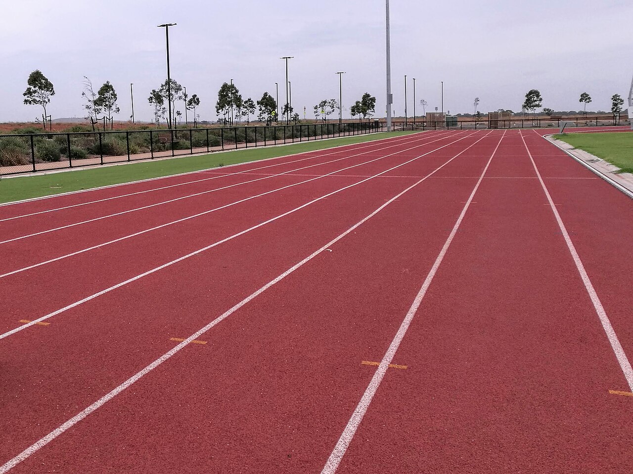 Red running track at a sports ground in Melton