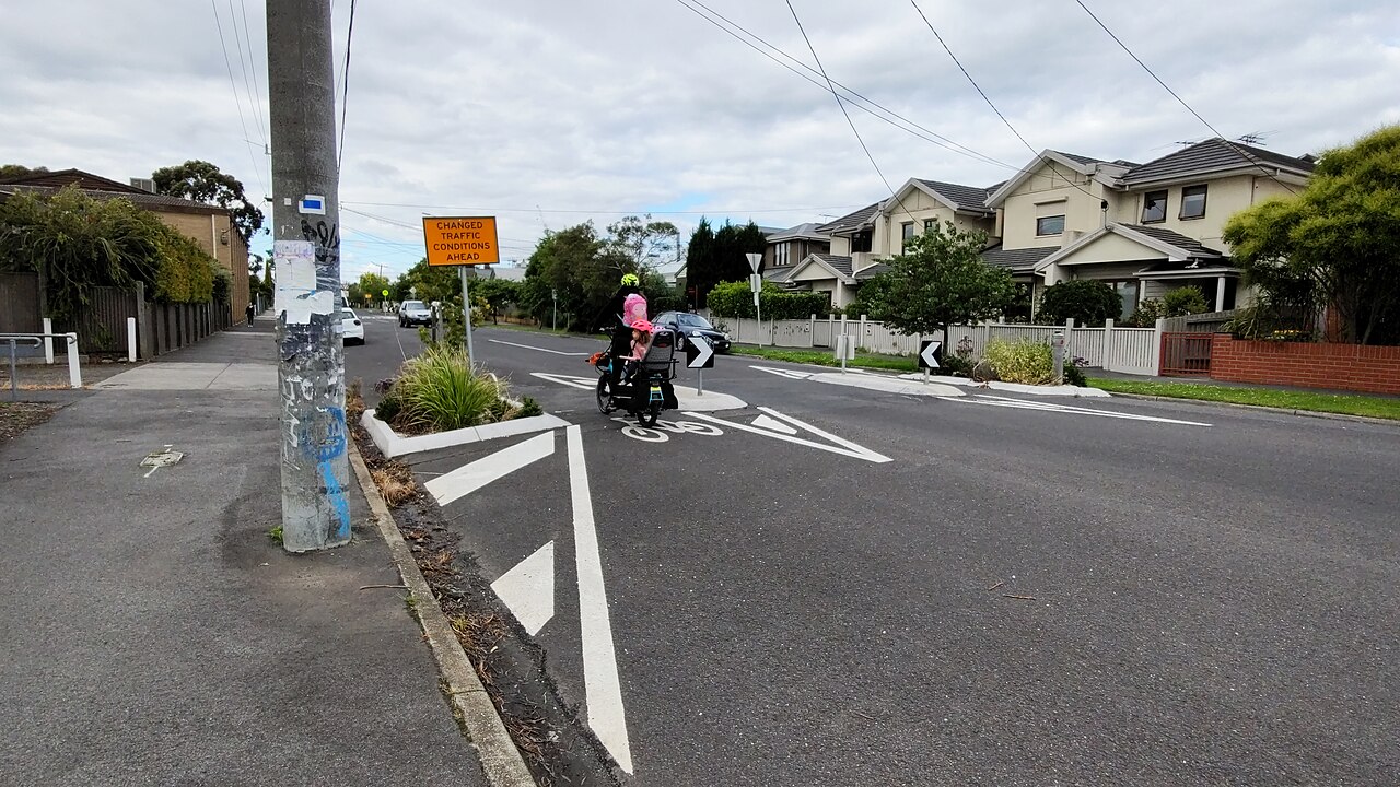 Traffic slow point with bicycle cut-throughs on a residential street