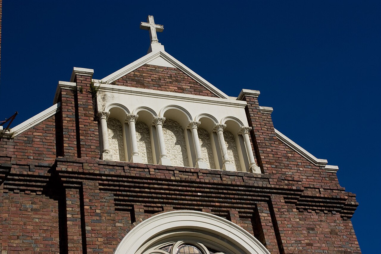 Roof and cross of St John's Church against blue sky