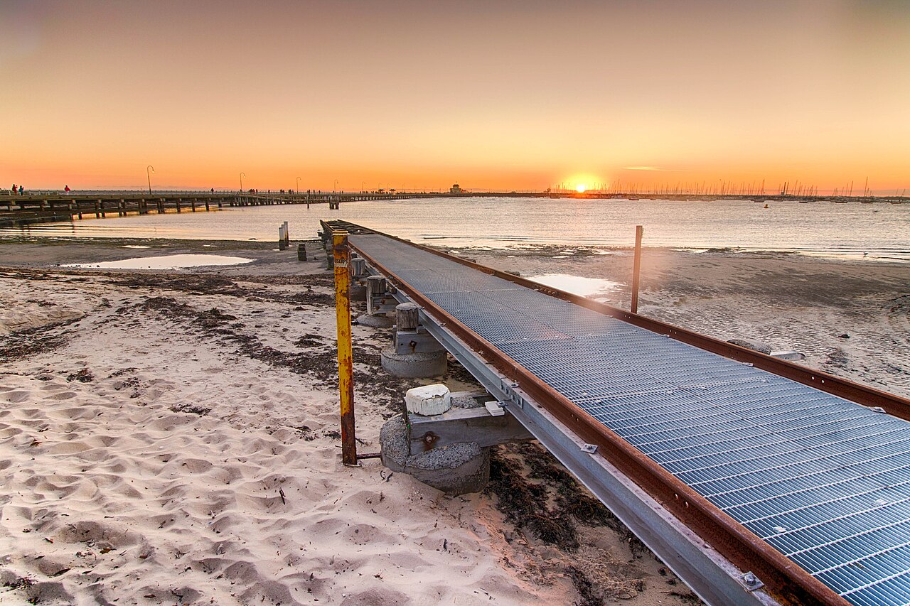 Wooden jetty at St Kilda Beach at sunset