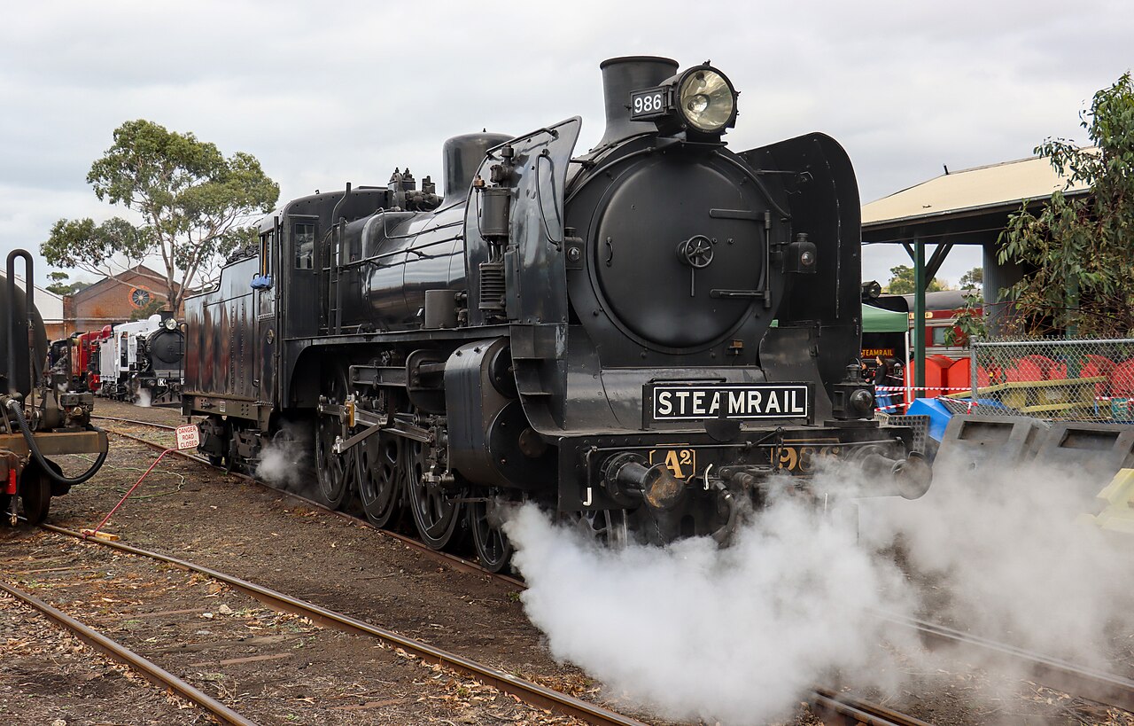 Steam locomotive A2 986 letting off steam in the rail yards