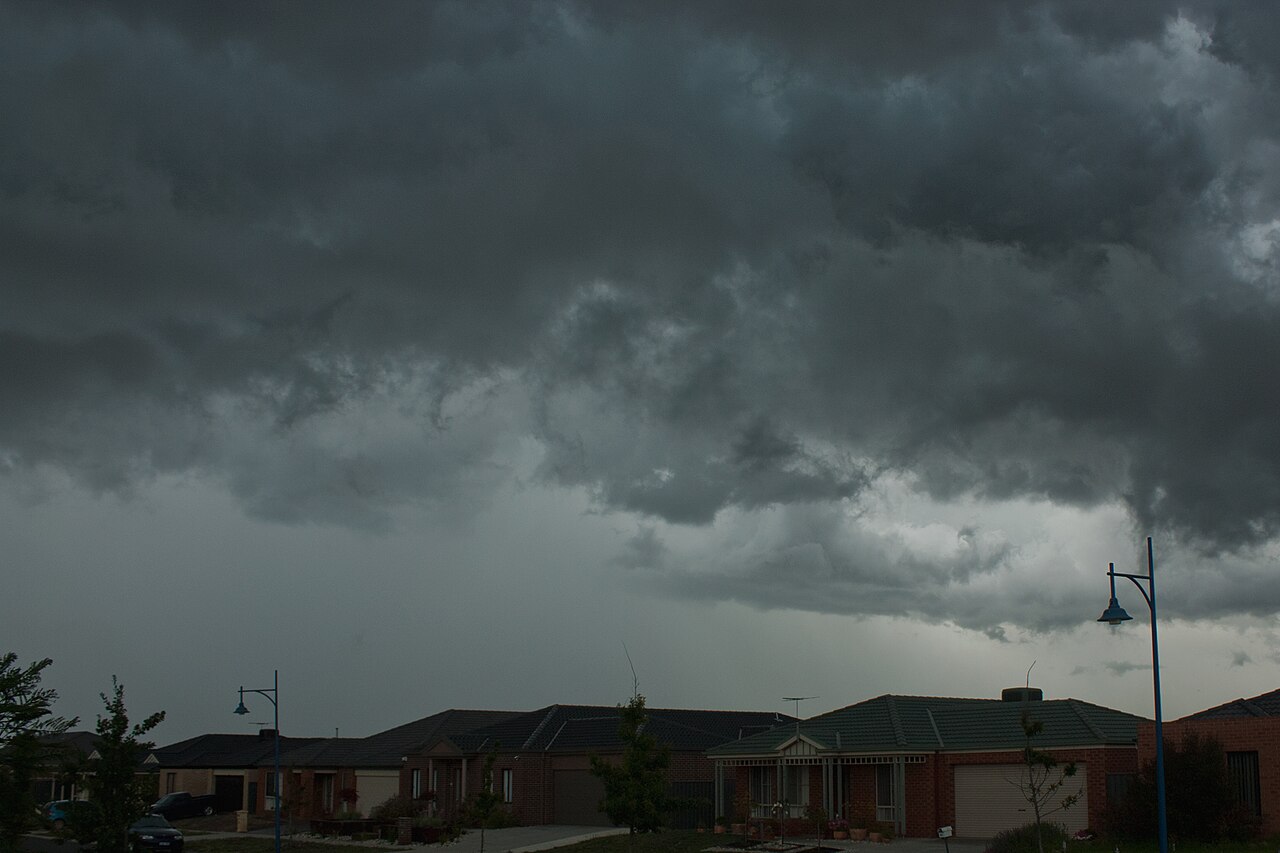 Storm clouds over a row of new houses