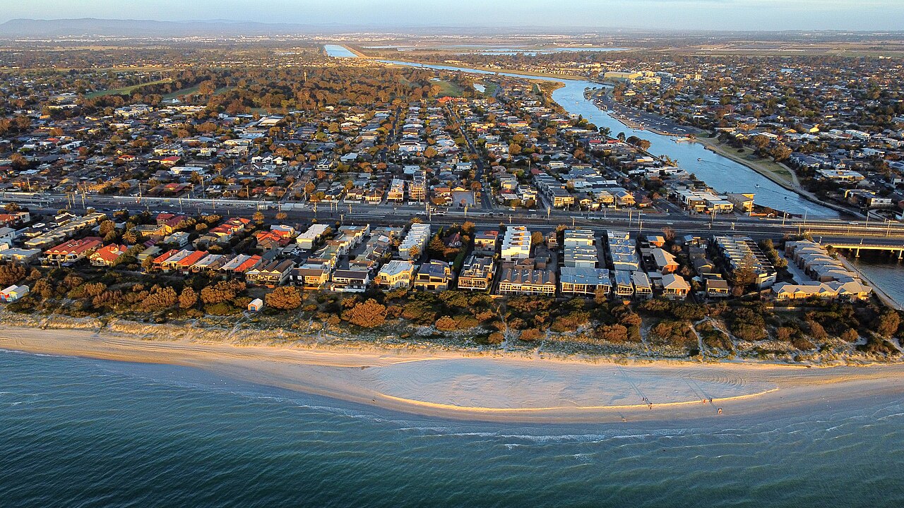 Aerial view of Bonbeach from the shore, with beach, houses and canals