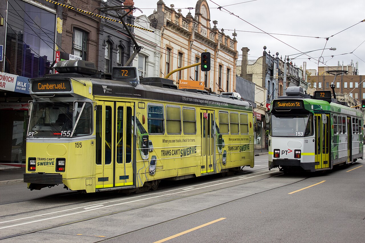 Two Z3-class trams passing on a shopping street