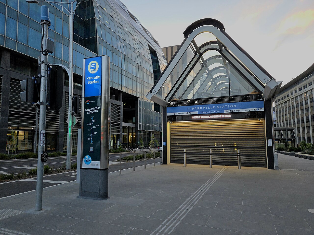 The glass-canopied Grattan Street entrance to Parkville railway station, Melbourne, with its Parkville Station totem sign