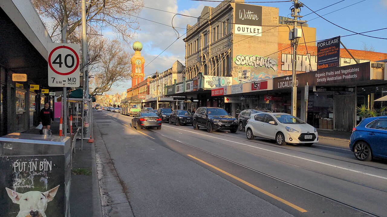 Swan Street, Richmond, with shops, traffic and the Dimmeys clock tower in the distance